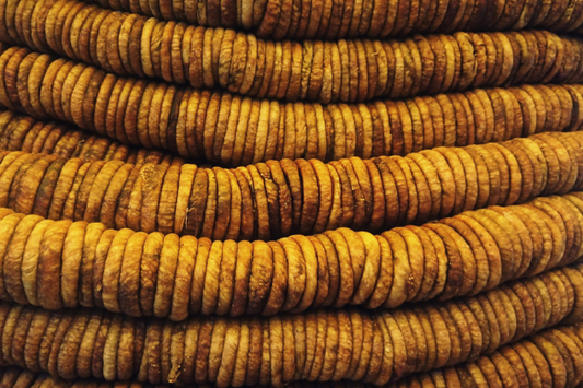 Traditional dried fig garland with golden-brown figs threaded on string in neat rows, displaying the authentic Kashmiri method of preserving and storing premium dry figs. Handcrafted fig rope from Kashmir Aesthetics."
This describes the distinctive rope/garland arrangement shown in your image, highlighting the traditional preservation method and connecting it to your Kashmir Aesthetics brand.